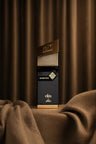 Momentum Eau de Parfum bottle and box on warm drapery