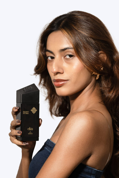 Model holding Silent Storm Eau de Parfum, unisex fragrance