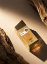 Sleek 100ml bottle and box on driftwood, House of Watan Elan